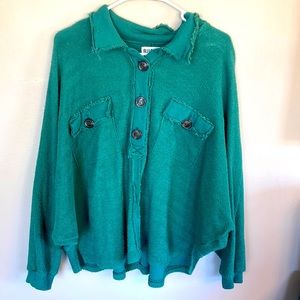 Green/dark teal women’s top with functional buttons